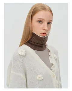 Close-up of soft 100% wool neck gaiter with decorative pearl edge and knit flowers