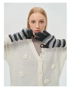 Detail of fingerless wool blend gloves with rainbow stripes in black and grey tones