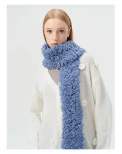 Detailed texture of blue curly wool scarf paired with white 3D flower knit cardigan