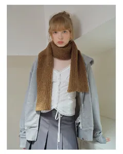 Detail of soft brown wool blend textured scarf styled with a grey hoodie and skirt