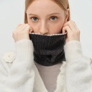 Dark grey ribbed wool neck gaiter paired with white floral knit cardigan for winter
