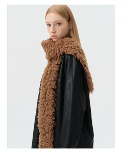 Detailed texture of brown curly wool knit scarf paired with a black leather jacket