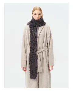 Close-up of curly dark grey wool scarf texture with elegant beige knit coat