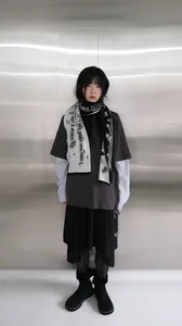 Detail of knitted jacquard scarf with gothic letters and snowflake pattern for women