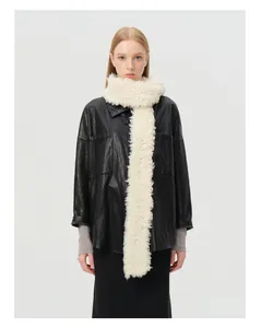 Close-up of cream white curly wool knit scarf with soft lambskin texture on a model
