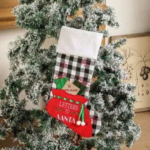 Buffalo plaid Christmas stocking with Letters to Santa pocket hanging on a festive tree