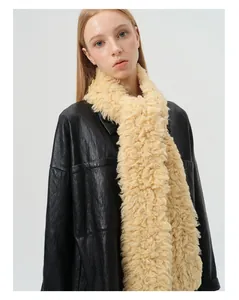 Close-up of fluffy cream wool scarf styled with a black leather jacket for winter