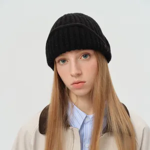 Women's black wool blend knit bomber hat featuring a thick ribbed texture for winter warmth