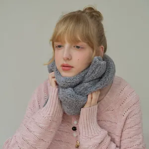 Soft grey wool blend knit scarf paired with a pink cardigan for a cozy winter style