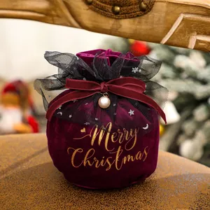 Deep red velvet Christmas gift bag with gold Merry Christmas print and pearl bow detail