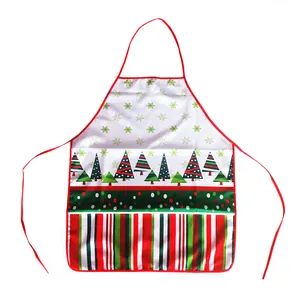 Close-up of festive Christmas apron with green snowflakes and decorative tree patterns