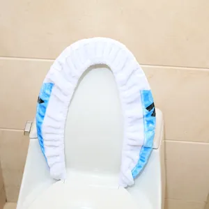 Detailed view of plush blue and white snowman toilet seat cover with snowflake patterns