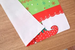 Macro detail of Christmas table mat showing festive elf pattern and plush backing