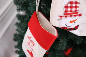 Detail of 20-inch linen Christmas stockings with Santa and snowman embroidery
