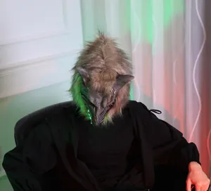 Realistic werewolf mask with glowing green eyes and detailed faux fur for Halloween
