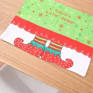 Christmas elf helper placemat with red and green elf shoes on wood background