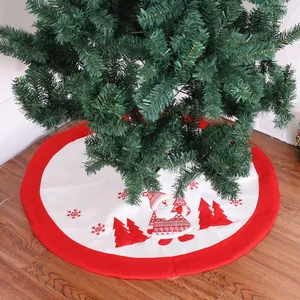 Classic red and white Christmas tree skirt with festive Santa Claus and snowflake embroidery