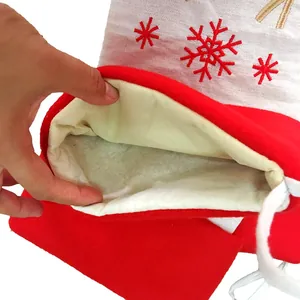 Detail of red Christmas stocking featuring white snowflake embroidery and soft lining