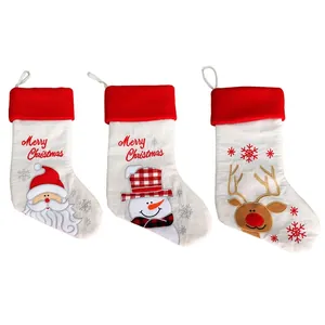 Close-up of three burlap Christmas stockings with Santa, Snowman and Reindeer embroidery