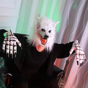 Macro shot of a scary white werewolf mask with sharp teeth and matching long claw gloves
