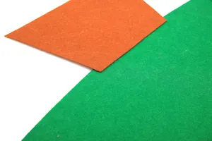 Detailed texture of high-quality orange and green felt fabric for Christmas DIY crafts
