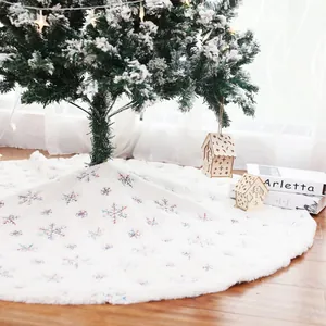 White plush Christmas tree skirt featuring colorful embroidered snowflake patterns
