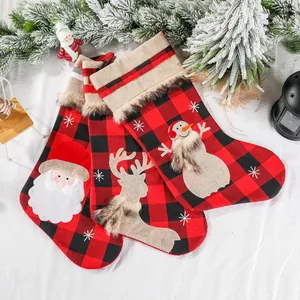 Three-piece set of red and black buffalo plaid Christmas stockings with plush trim