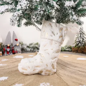 White faux fur Christmas stocking with golden feather patterns for holiday home decoration