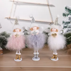 Detailed view of handmade Christmas angel doll ornaments with feather skirts and wings