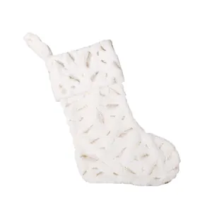 White faux fur Christmas stocking with golden feathers and hanging loop for holiday decor
