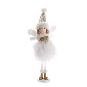 Detailed view of Christmas angel doll with white feathers and gold sequins on white background