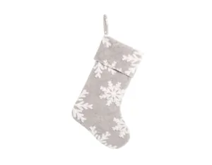 Detail view of plush grey Christmas stocking featuring large white snowflake patterns