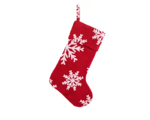 Detail of red plush Christmas stocking with white snowflake patterns and hanging loop
