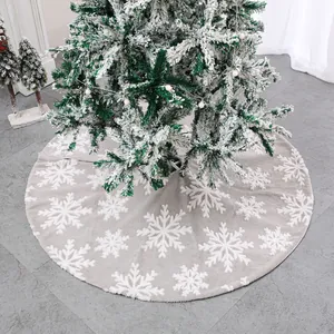 Plush grey Christmas tree skirt with large white snowflake patterns for holiday decor