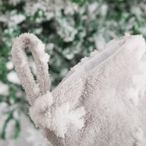 Grey plush Christmas stocking with white snowflake tufted pattern for holiday decor