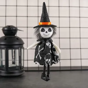 Halloween skeleton doll with witch hat and patterned dress hanging on black decor