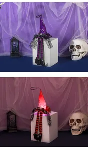 Detail of LED glowing Halloween witch hat pendants with striped long legs and sequins