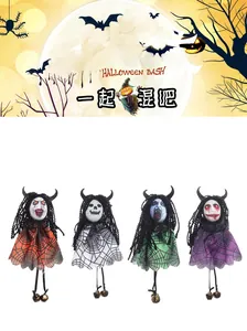 Detail of four Halloween ghost dolls with spider web tulle skirts and metal bells