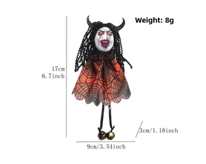 Detail showing 17cm Halloween ghost doll with orange spiderweb dress and bronze bells