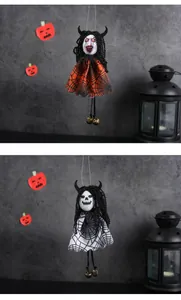 Detail of hanging Halloween witch and skeleton figures with spiderweb dresses and bells