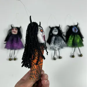 Detail of spooky Halloween ghost doll with orange spiderweb dress and long black hair