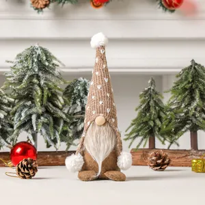 Christmas gnome doll with heart knitted hat and white beard in a festive home setting