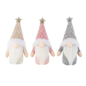 Three Christmas gnomes with knitted snowflake hats and shiny stars for festive decoration