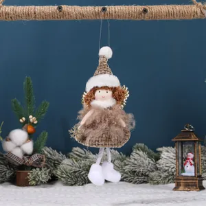 Handmade plush Christmas angel ornament with golden wings and snowflake on a festive tree