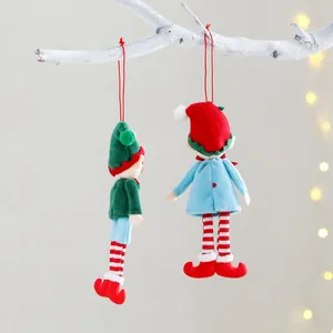 Pair of plush Christmas elf hanging ornaments with striped legs on a white branch