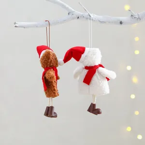 Christmas plush bear and snowman ornaments with red hats on festive warm background