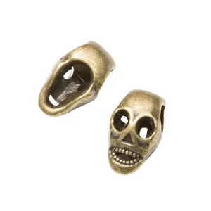 Vintage bronze skull beads for DIY jewelry making with retro distressed finish details