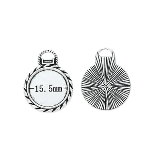 Detail of 15.5mm retro silver alloy round pendant base with textured sunburst back