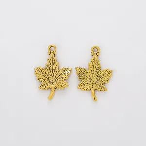 Close-up of golden maple leaf pendants with detailed veins and top hanging holes