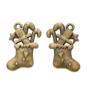 Vintage bronze Christmas stocking charm with gingerbread man and candy cane for DIY jewelry
